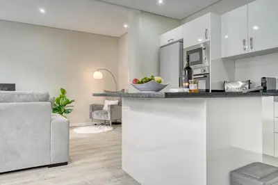 a kitchen and living room with a counter and a couch at Tristão Vaz I, a Home in Madeira in Machico