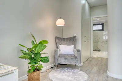 a living room with a chair and a plant at Tristão Vaz I, a Home in Madeira in Machico