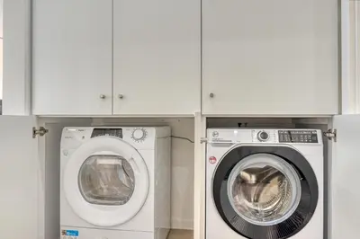a laundry room with a washer and a washing machine at Tristão Vaz I, a Home in Madeira in Machico