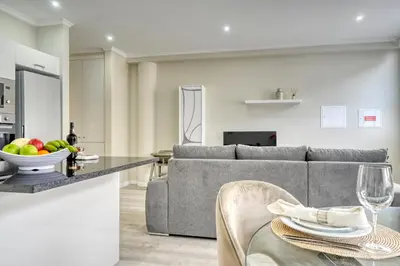 a living room with a gray couch and a table at Tristão Vaz II, a Home in Madeira in Machico