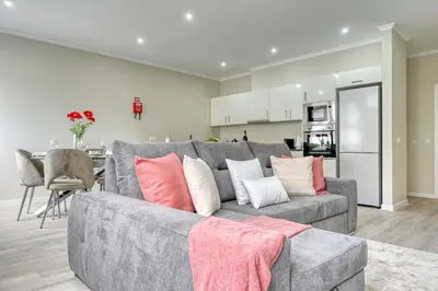 a living room with a gray couch with pillows at Tristão Vaz II, a Home in Madeira in Machico