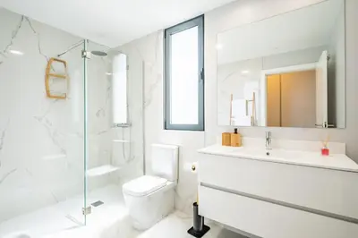 a bathroom with a toilet and a sink and a shower at Apartment with ocean view and parking in Funchal