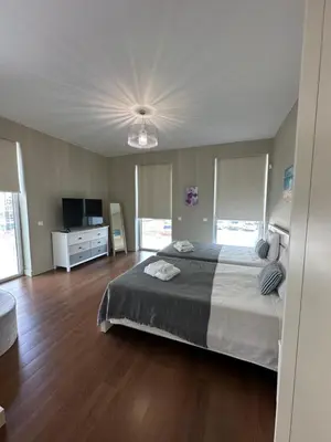 a bedroom with a large bed and a television at Madeira Palace Residences in Funchal