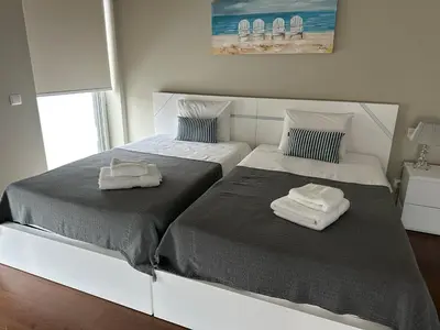 two beds sitting next to each other in a bedroom at Madeira Palace Residences in Funchal