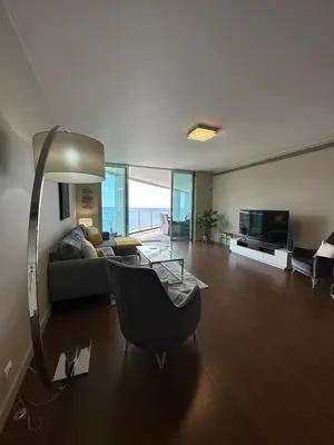 a living room with a couch and a television at Madeira Palace Residences in Funchal
