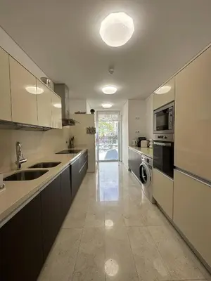 a large kitchen with a sink and a dishwasher at Madeira Palace Residences in Funchal