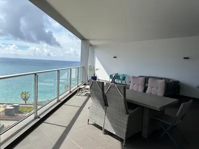 a balcony with a table and chairs and the ocean at Madeira Palace Residences in Funchal