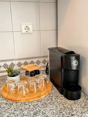 a counter top with a coffee maker and some glasses at Stay In Madeira in Funchal