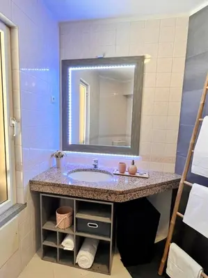 a bathroom with a sink and a mirror at Stay In Madeira in Funchal
