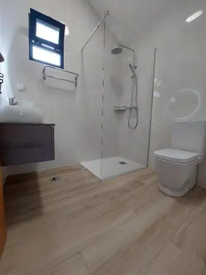 a bathroom with a shower and a toilet and a sink at The Passion Fruit House in São Vicente
