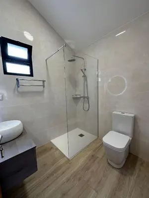 a bathroom with a shower and a toilet and a sink at The Passion Fruit House in São Vicente