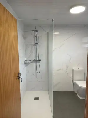 a bathroom with a shower and a toilet at The Passion Fruit House in São Vicente
