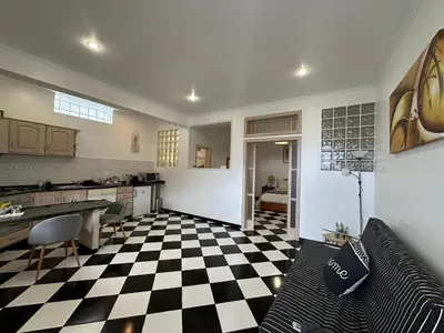 a living room with a black and white checkered floor at Residência Mendonça in Faial