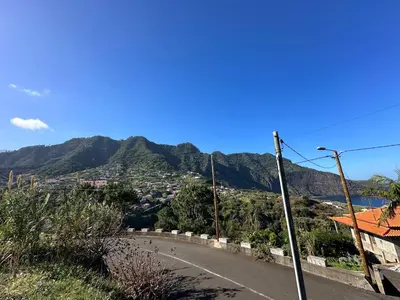 an empty road with a mountain in the background at Residência Mendonça in Faial