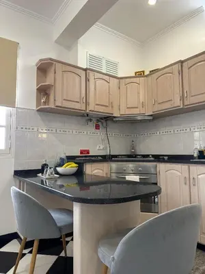 a kitchen with a island in the middle of a room at Residência Mendonça in Faial