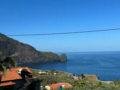 a view of a body of water with mountains at Residência Mendonça in Faial