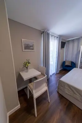 a bedroom with a desk and a bed and a table at Blue House in Ponta do Sol