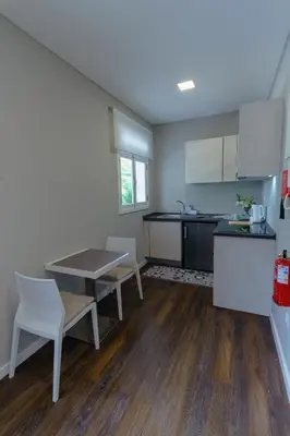 a kitchen with a table and chairs in a room at Blue House in Ponta do Sol