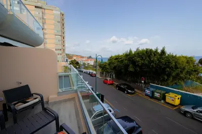 a balcony of a building with a view of a street at Sea Breeze III in Caniço