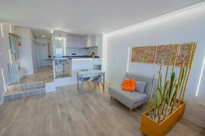 a living room with a couch and a table at Sea Breeze III in Caniço