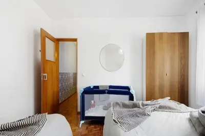 a bedroom with two beds and a mirror and a door at Casa Branca in Luz