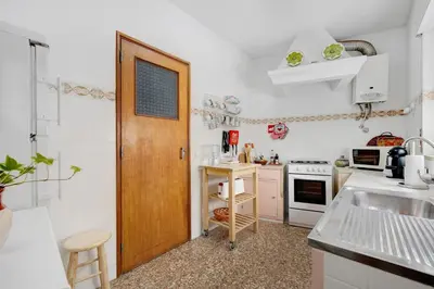 a kitchen with a wooden door and a counter top at Casa Branca in Luz