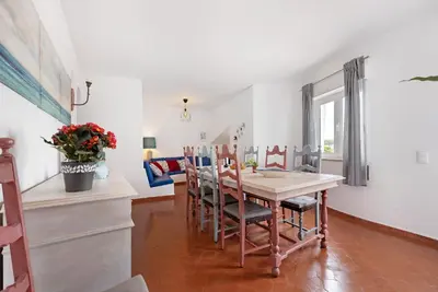 a dining room with a table and chairs at Casa Branca in Luz