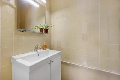 a bathroom with a white sink and a mirror at Casa Branca in Luz