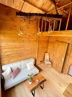 a living room with a couch and a table at Mountain Eco Shelter 6 in Funchal
