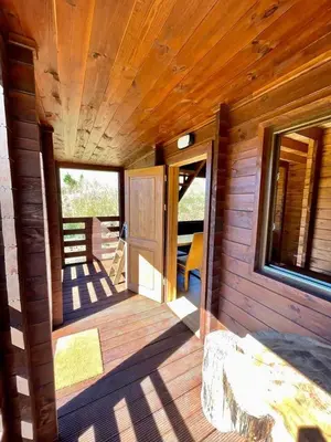 a porch of a wooden cabin with a door at Mountain Eco Shelter 6 in Funchal