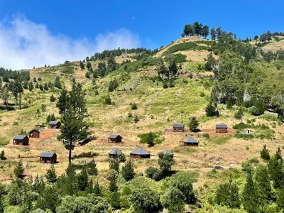 a group of huts on a grassy hill at Mountain Eco Shelter 6 in Funchal