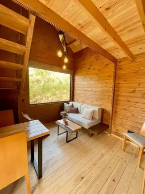 a room with a bench and a table in a cabin at Mountain Eco Shelter 6 in Funchal