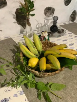 a basket of bananas and lemons on a table at Waves Song - Cottage in Porto Moniz