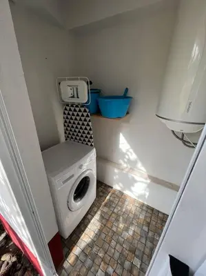 a small bathroom with a washing machine in a room at Waves Song - Cottage in Porto Moniz
