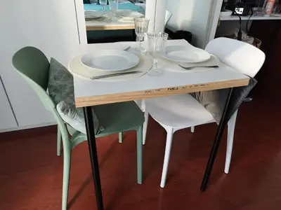 a white table with chairs and plates on it at Alexia Room in Funchal