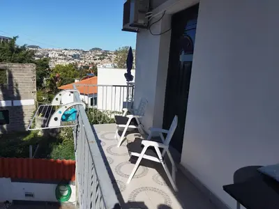 a view of a city from a white building at Alexia Room in Funchal