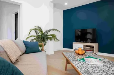a living room with a couch and a tv at GuestReady - Hillside Oceanview Heaven in Funchal