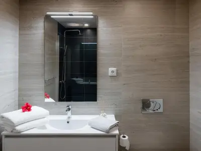 a bathroom with a sink and a mirror at GuestReady - Hillside Oceanview Heaven in Funchal