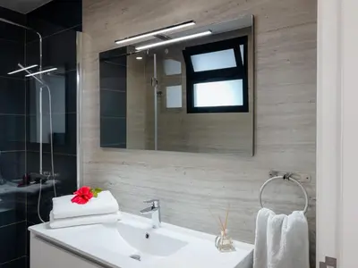 a bathroom with a sink and a mirror at GuestReady - Hillside Oceanview Heaven in Funchal