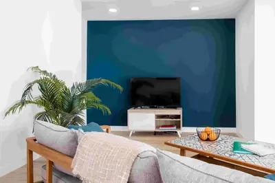 a living room with a blue wall at GuestReady - Hillside Oceanview Heaven in Funchal
