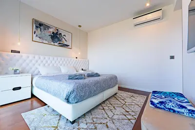 a bedroom with a white bed and a white dresser at Serenity by the Sea in Funchal