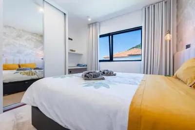a bedroom with a large bed and a large window at Serenity by the Sea in Funchal