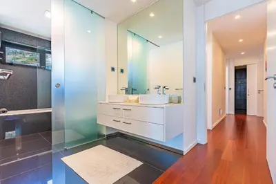 a bathroom with two sinks and a large mirror at Serenity by the Sea in Funchal