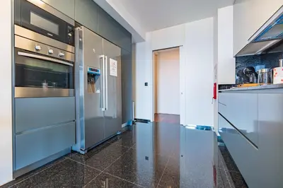 a kitchen with stainless steel refrigerators in a room at Serenity by the Sea in Funchal