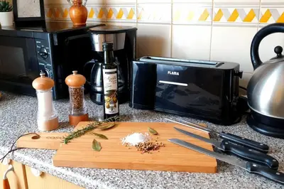 a kitchen counter with a cutting board and a microwave at Entire flat 70sq m at Luz just 400m beach distance in Luz