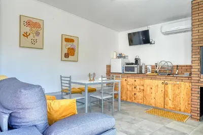 a living room with a blue couch and a table at Studio 92, a Home in Madeira in Ponta do Sol