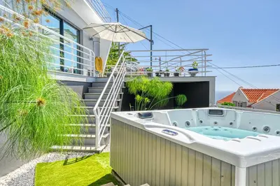 a hot tub in the backyard of a house at Studio 92, a Home in Madeira in Ponta do Sol
