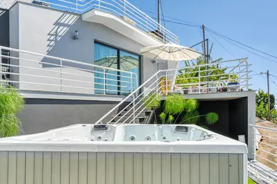 a bath tub on the side of a house at Studio 92, a Home in Madeira in Ponta do Sol