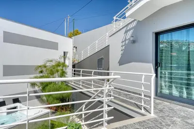 a balcony of a house with white railing at Studio 92, a Home in Madeira in Ponta do Sol