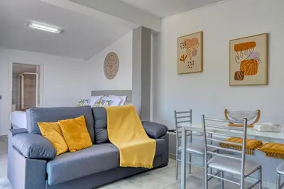 a living room with a blue couch and a table at Studio 92, a Home in Madeira in Ponta do Sol